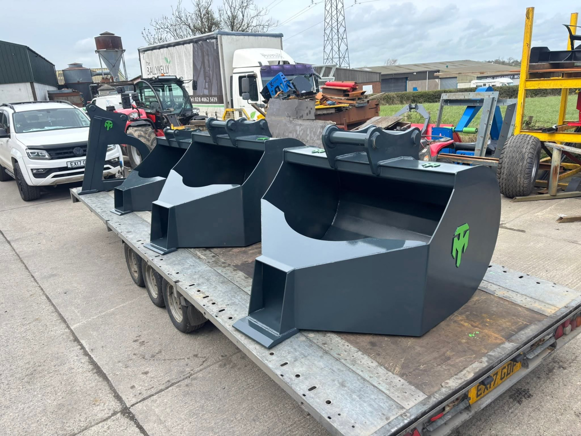 Batch of MT Plant concrete pouring buckets on a flatbed trailer